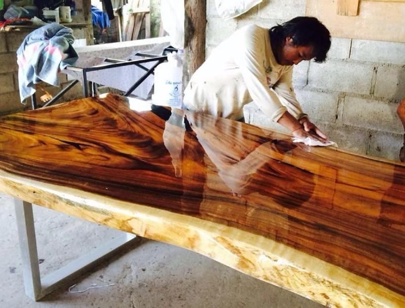 Woodworker Hand Finishing Acacia Wood Live Edge Table